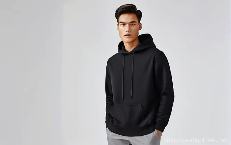 남성용 오버사이즈 패션 - A fashionable man, early 30s, showcasing a sophisticated oversized layered look. He is wearing a thi...